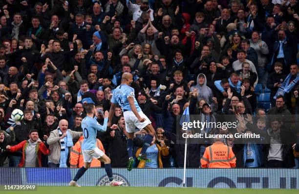 Vincent Kompany of Manchester City celebrates after scoring his team's first goal with Bernardo Silva of Manchester City during the Premier League...