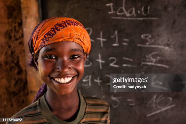 african little girl during math class, southern ethiopia, east africa - poverty girl stock pictures, royalty-free photos & images