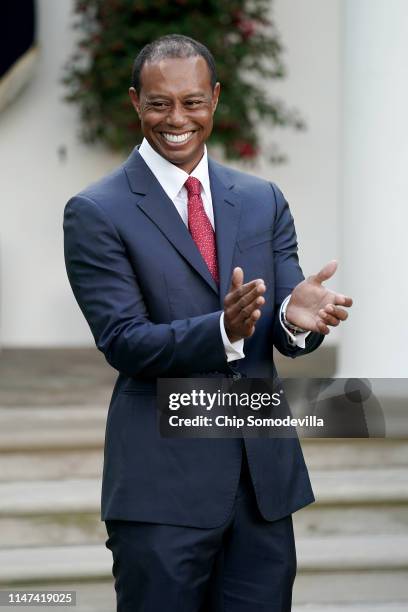 Professional golfer Tiger Woods applauds during his Medal of Freedom ceremony in the Rose Garden at the White House May 06, 2019 in Washington, DC....