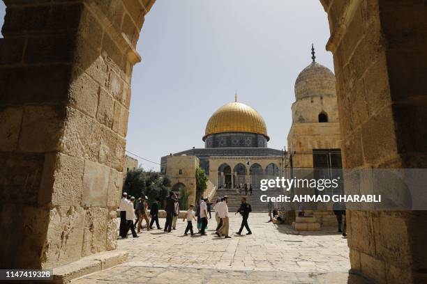 Israeli security forces escort a group of Jewish settlers visiting the Al-Aqsa Mosque compound, revered as the site of two ancient Jewish temples,...