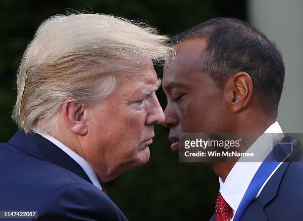 President Donald Trump presents professional golfer and business partner Tiger Woods with the Medal of Freedom during a ceremony in the Rose Garden...