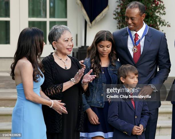 Professional golfer Tiger Woods is joined by his mother Kultida Woods , children Sam Alexis Woods and Charlie Axel Woods and girlfriend Erica Herman...