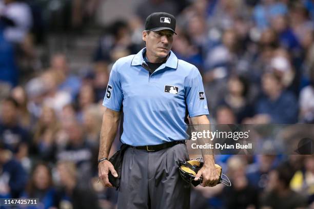 Umpire Angel Hernandez looks on during the game between the New York Mets and Milwaukee Brewers at Miller Park on May 04, 2019 in Milwaukee,...