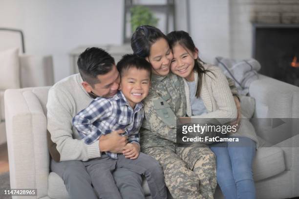 famiglia militare seduta sul divano - filipino family reunion foto e immagini stock