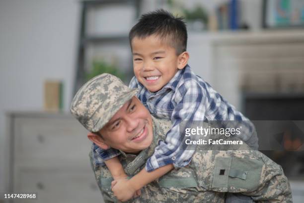 hugging dad - filipino family reunion stock pictures, royalty-free photos & images
