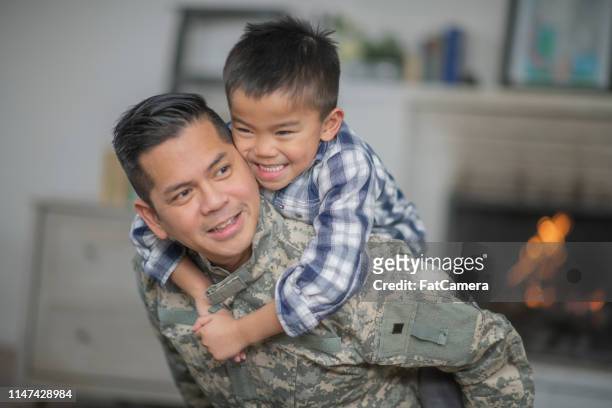 hugging dad - filipino family reunion stock pictures, royalty-free photos & images