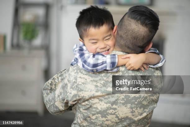 giving dad a big hug - filipino family reunion stock pictures, royalty-free photos & images