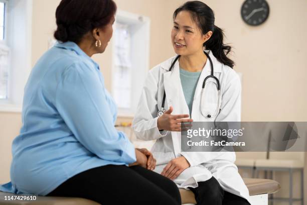 senior woman at the doctor - diabetes pills stock pictures, royalty-free photos & images