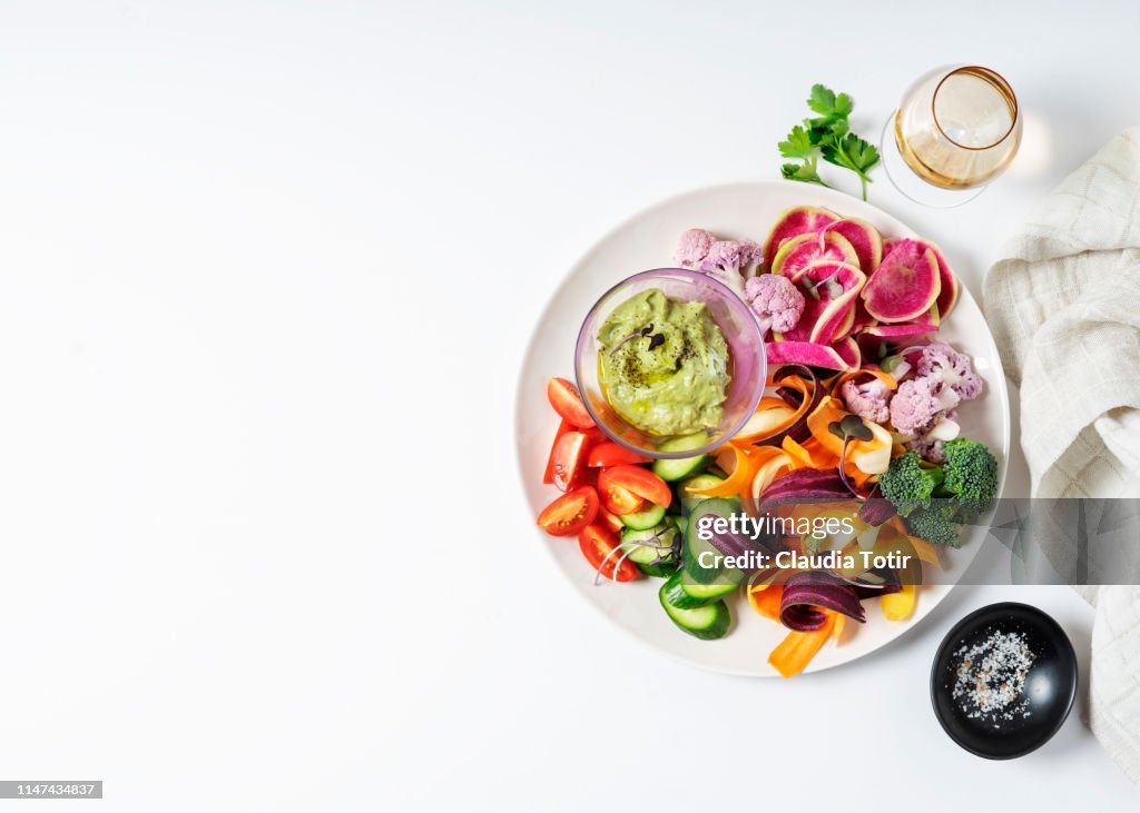 A platter of chopped vegetables on white background