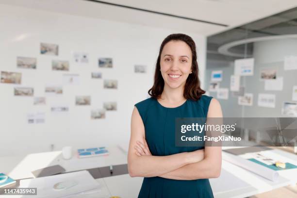 portrait of woman standing in design office - intelligence agency stock pictures, royalty-free photos & images