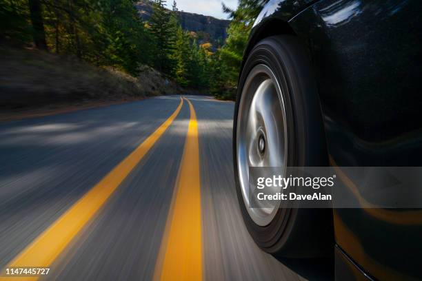 black sports car motion country road. - car speeding imagens e fotografias de stock