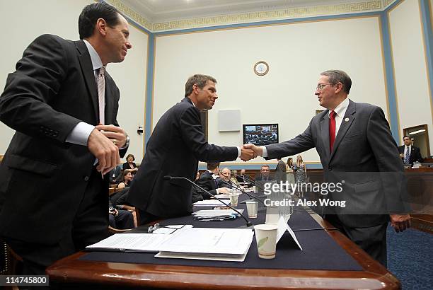 Subcommittee chairman Rep. Bob Goodlatte shakes hands with CEO of Deutsche Telekom AG Rene Obermann as Chairman, CEO and president of AT&T Randall...