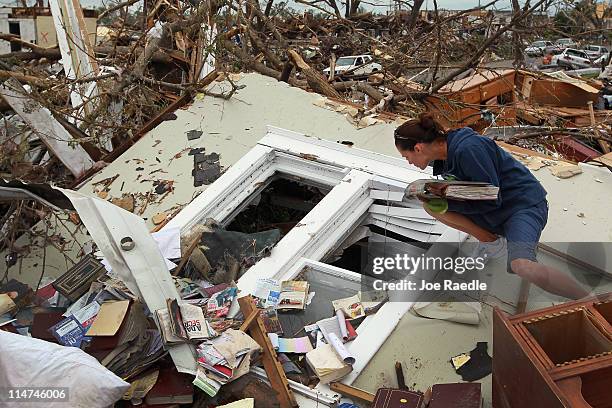 Lola Elbert helps look for items to salvage from her grandmother's house after it was destroyed when a massive tornado passed through the town...