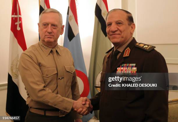 Egyptian Chief of Staff of the Armed Forces Sami Anan shakes hands with US Commander of the Central Command James Mattis during a meeting in Cairo on...