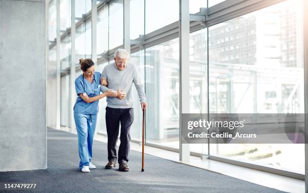 seniors always need someone to lean on - nurse walking stock pictures, royalty-free photos & images