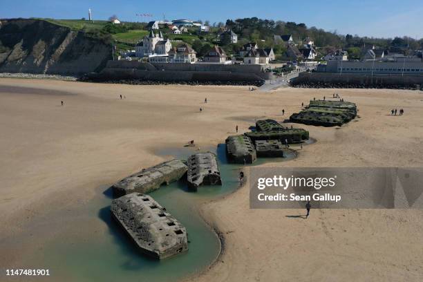 In this aerial view pontoons from the World War II Allied temporary Mulberry harbor built during the D-Day invasion lie on the beach on April 30,...