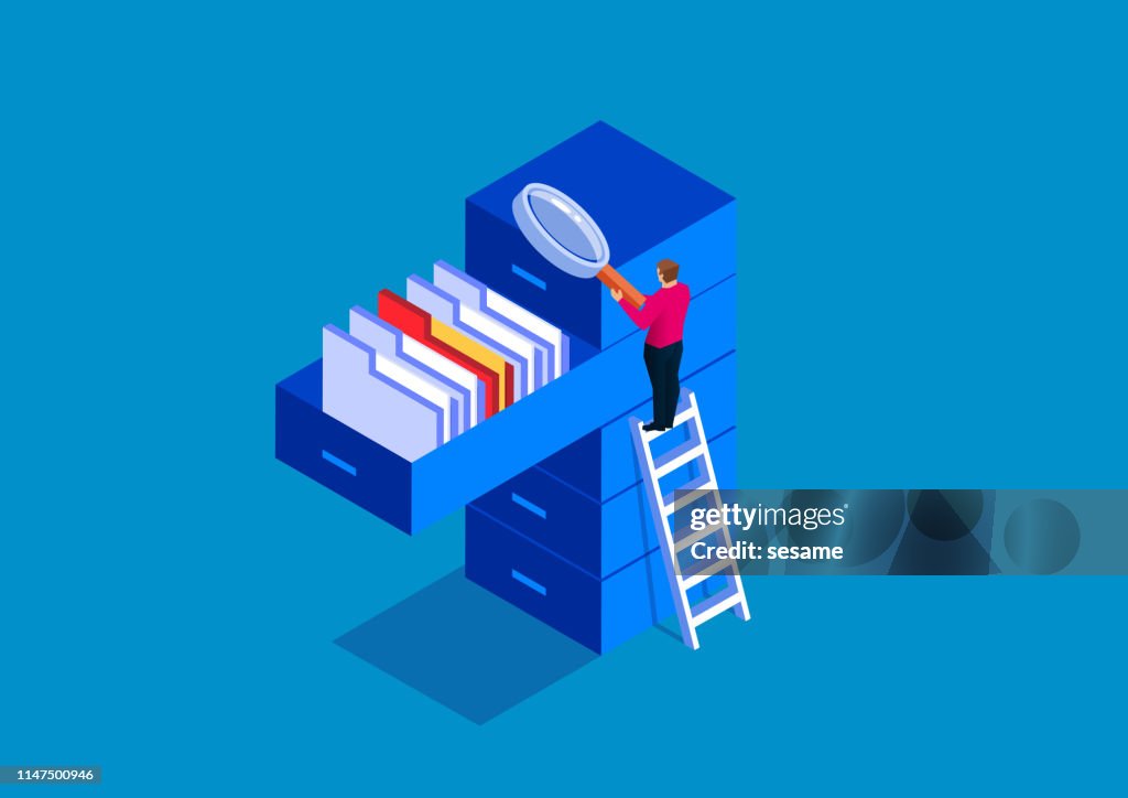 Businessman holding magnifying glass looking for documents