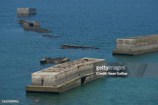 The remains of the World War II Allied temporary Mulberry harbor built during the D-Day invasion lie at Cap Manvieux on April 30, 2019 near...