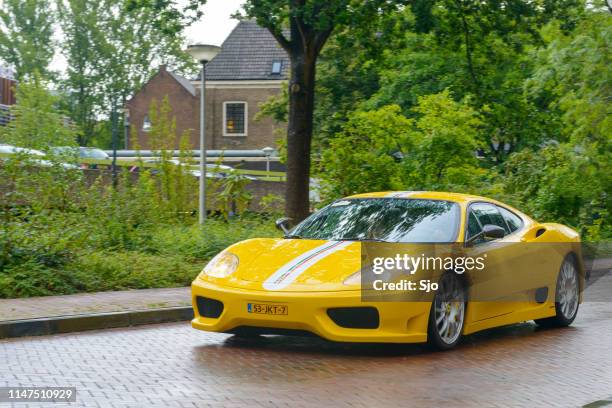 ferrari 360 modena challenge stradale sports car in the rain - tail light stock pictures, royalty-free photos & images