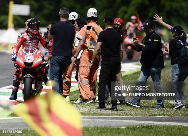 Italy's Andrea Dovizioso celebrates with his team after placing third of the Italian Moto GP Grand Prix at the Mugello race track on June 2, 2019 in...