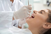 Closeup of woman lying on dental chair with open mouth
