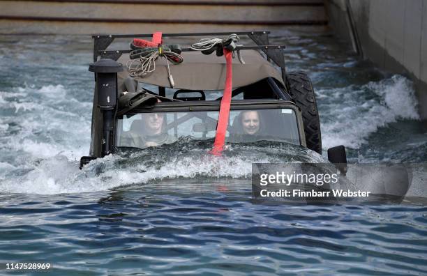 Modern waterproofed Land Rover goes through the dip tank during a demonstration of old and modern vehicles in action at RM Instow, Bideford in Devon...