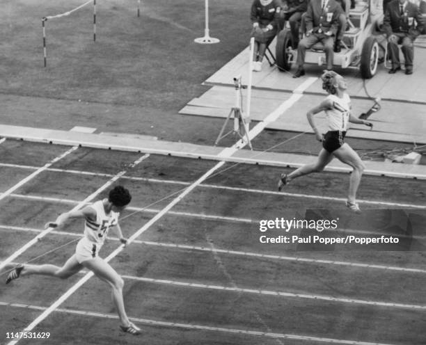 Australian athlete Betty Cuthbert finishes in first place to win the gold medal for Australia, ahead of Ann Packer of Great Britain, in the final of...