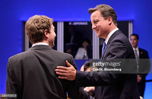 David Cameron, U.K. Prime minister, right, listens to Mark Zuckerberg, founder of Facebook Inc., left, during the internet session of the Group of...