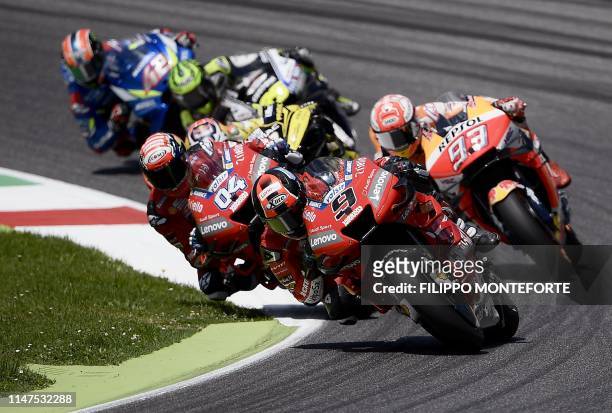 Italy's Danilo Petrucci riding his Ducati , Italy's Andrea Dovizioso riding his Ducati and Spain's Marc Marquez riding his Honda compete during the...