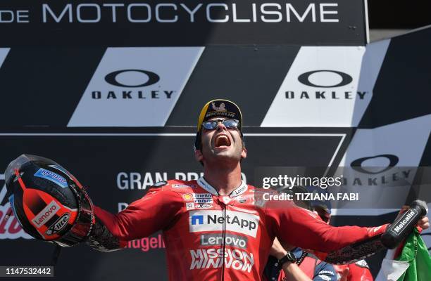 Italy's Danilo Petrucci celebrates on the podium after winning the Italian Moto GP Grand Prix at the Mugello race track on June 2, 2019 in Scarperia...