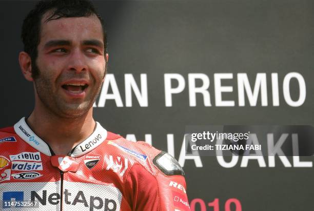 Italy's Danilo Petrucci celebrates on the podium after winning the Italian Moto GP Grand Prix at the Mugello race track on June 2, 2019 in Scarperia...