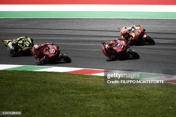 Australia's Jack Miller, Italy's Andrea Dovizioso, Italy's Danilo Petrucci and Spain's Marc Marquez compete during the Italian Moto GP Grand Prix at...