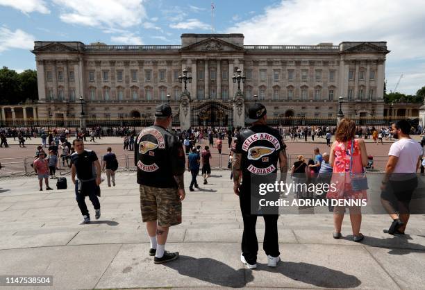Tourists wearing Hells Angels, Indiana jackets look towards Buckingham Palace, the official residence of Britain's Queen Elizabeth, in central London...