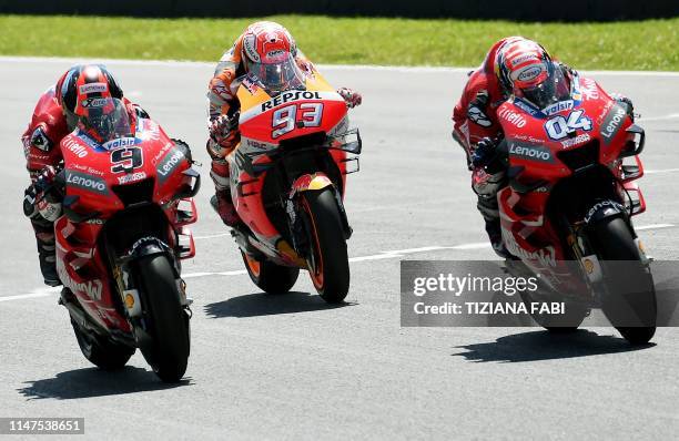 Italy's Danilo Petrucci, Spain's Marc Marquez and Italy's Andrea Dovizioso compete during the Italian Moto GP Grand Prix at the Mugello race track on...