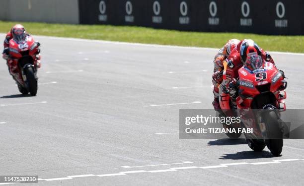 Italy's Danilo Petrucci, Spain's Marc Marquez and Italy's Andrea Dovizioso compete on their way to cross the finish line during the Italian Moto GP...