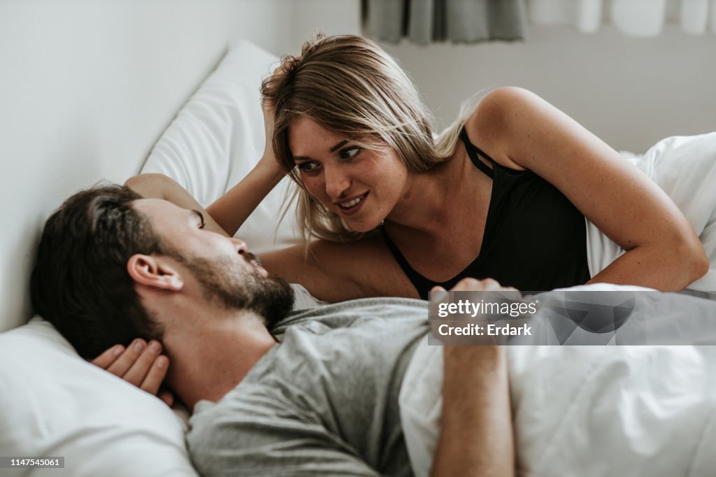 Romantic moment: Happy couple in love in the bed - Stock image