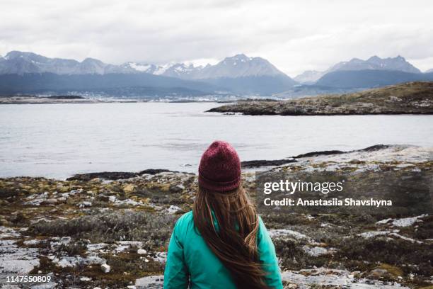 woman exploring the beagle channel in ushuaia - ushuaia stock pictures, royalty-free photos & images