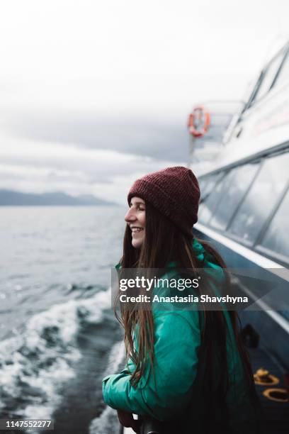 woman looking at ocean from the ship in ushuaia - ushuaia stock pictures, royalty-free photos & images