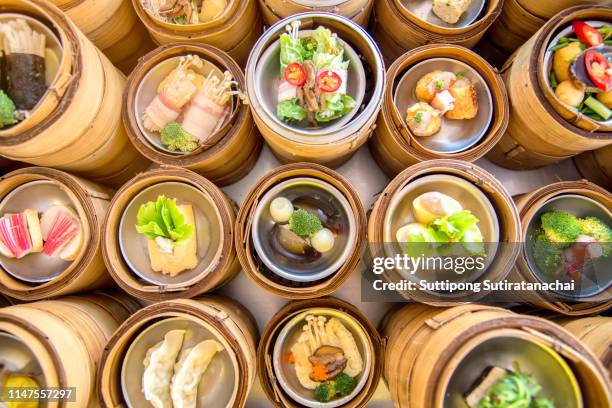 many kind of boil yumcha, dim sum in bamboo steamer, chinese cuisine - hong kong food stock-fotos und bilder