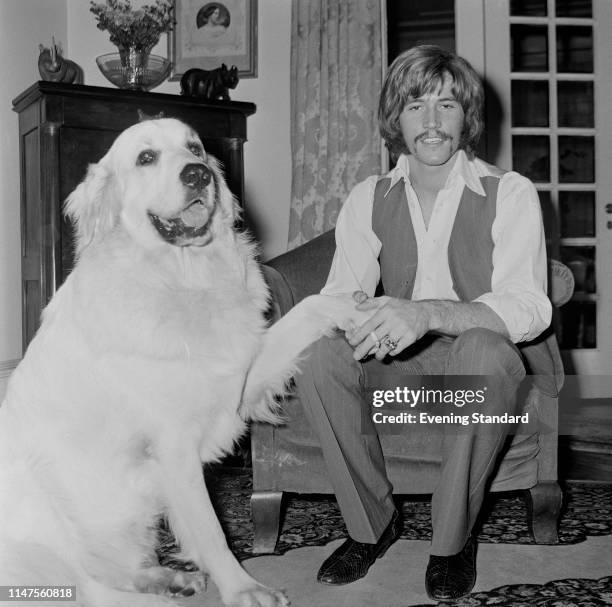 English singer, songwriter, musician and record producer Barry Gibb of the Bee Gees with his Pyrenean Mountain dog Barnaby, UK, 3rd October 1969.