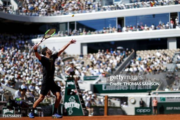 Argentina's Juan Ignacio Londero serves the ball to Spain's Rafael Nadal during their men's singles fourth round match on day eight of The Roland...