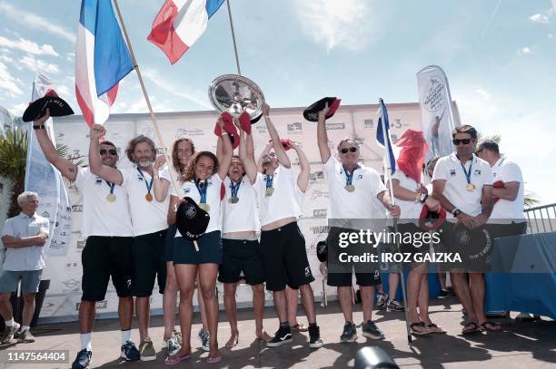 France's competitors, Justine Dupont , Alice Lemoigne , Edouard Delpero , Antoine Delpero and team members pose with the world team champion trophy...