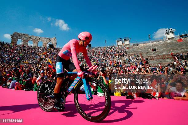 Overall race winner Team Movistar rider Ecuador's Richard Carapaz reacts as he enters the arena after competing in stage twenty-one, the final stage...