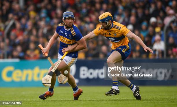 Clare , Ireland - 2 June 2019; Jason Forde of Tipperary in action against Seadna Morey of Clare during the Munster GAA Hurling Senior Championship...