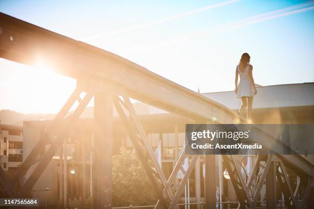 couple walk along bridge at sunset - freiburg im breisgau stock pictures, royalty-free photos & images