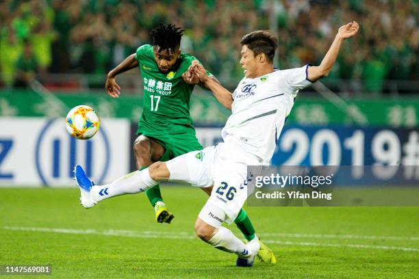 Cedric Bakambu of Beijing Guoan and Hong Jeong-Ho of Jeonbuk Hyundai Motors compete for the ball during the AFC Champions League Group G match...