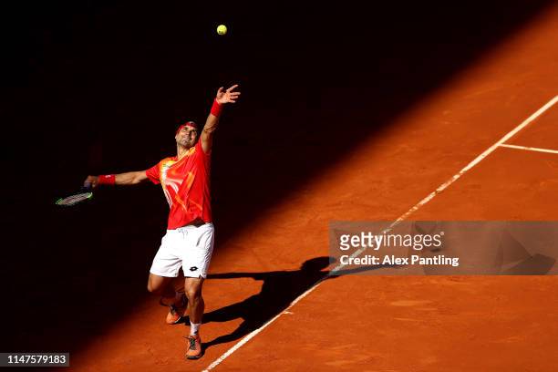 David Ferrer of Spain serves in his match against Roberto Bautista Agusta during day four of the Mutua Madrid Open at La Caja Magica on May 07, 2019...