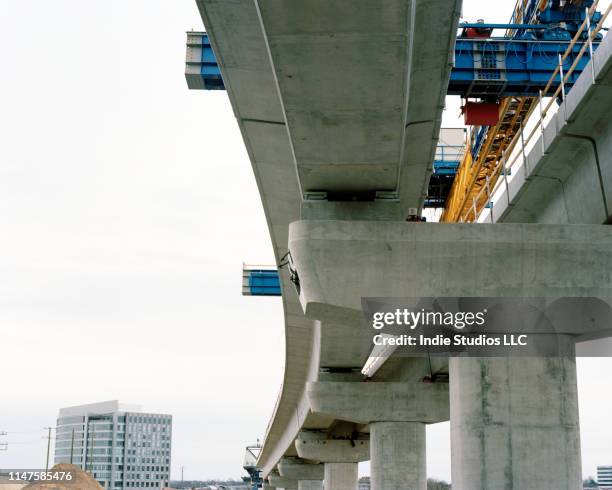 film photograph of dc metro silver line being built in tyson corner from directly below the elevated section of track - lightrail stock pictures, royalty-free photos & images