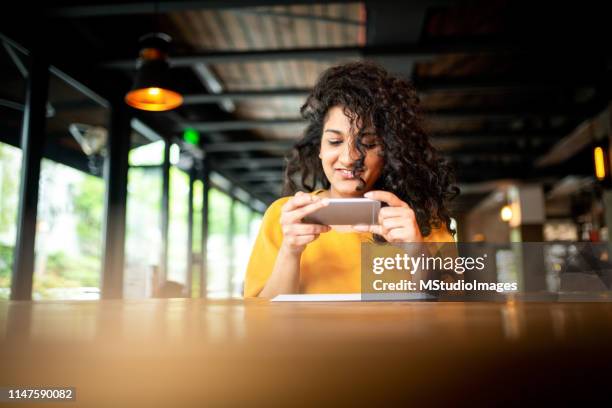 check remote deposit capture at coffee shop - cheque deposit stock pictures, royalty-free photos & images