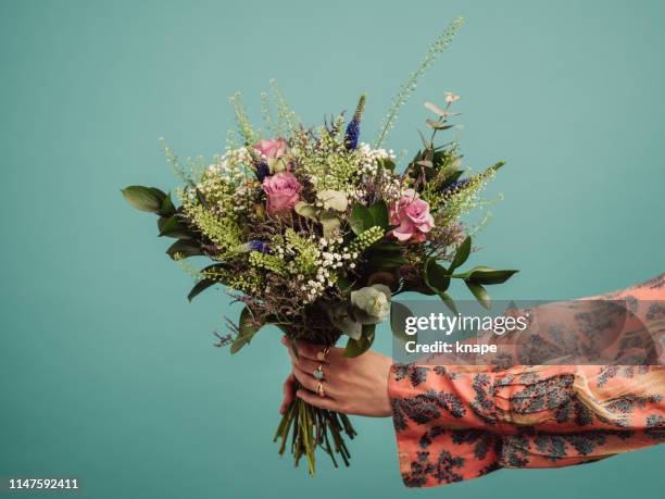 woman holding a big bouquet of flowers - bouquet imagens e fotografias de stock